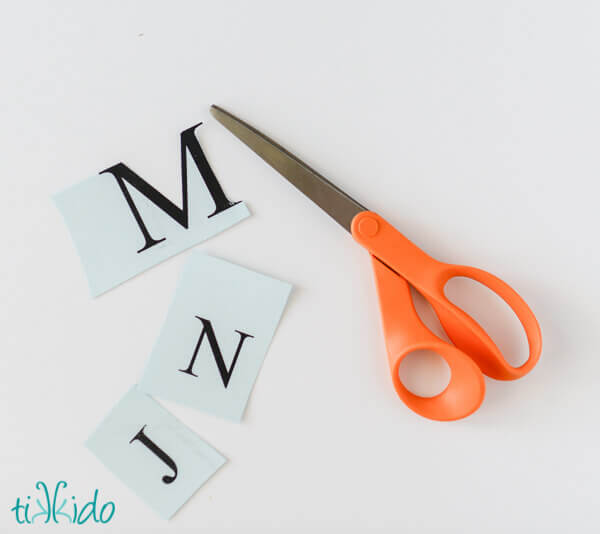 Monogram letters being cut out of heavy card stock for making a Nautical Monogram Cake Topper.