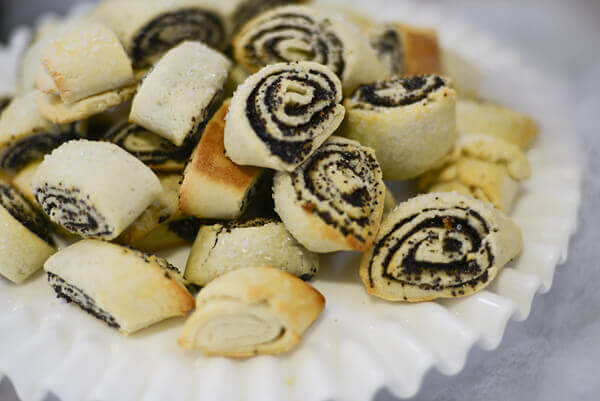 White cake plate piled with Poppy Seed Rugelach.