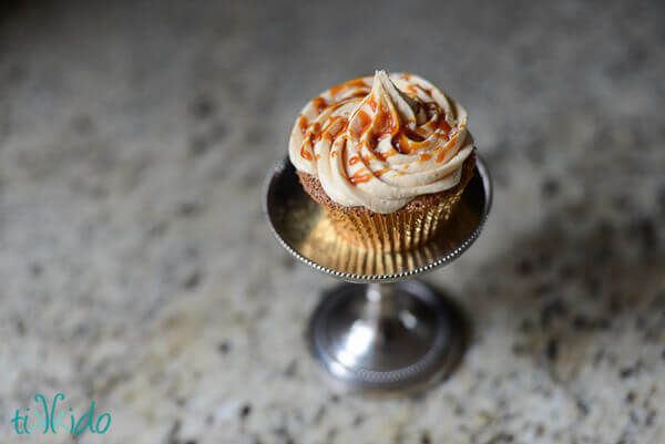 Cupcake topped with salted caramel buttercream and drizzled with salted caramel sauce.