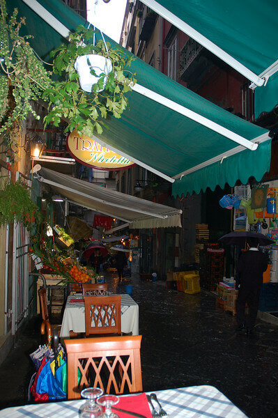 Trattoria in a narrow alleyway in Naples, Italy.