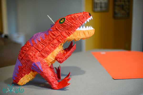 Store bought dinosaur pinata ready to be transformed into an easy DIY Dragon piñata.