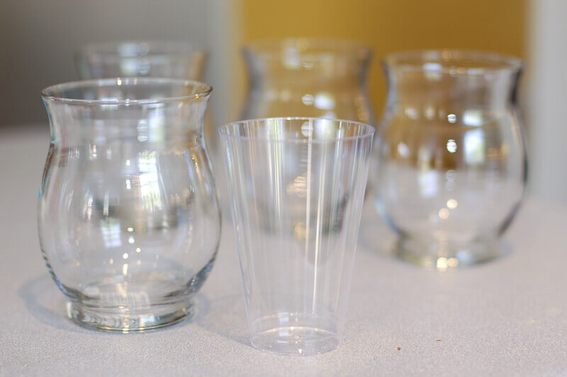 Small clear vases and clear plastic cups for making DIY nested vases.