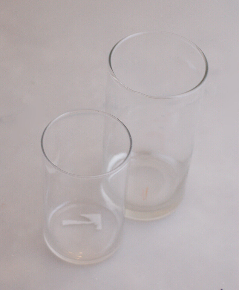 Two sizes of clear cylinder vases for making nested, filled vases.