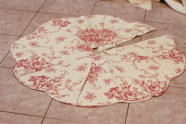 Pieces of an easy Quilted Christmas Tree Skirt laid out on the floor.