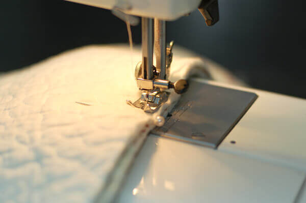 Sewing machine foot sewing a Quilted Christmas Tree Skirt