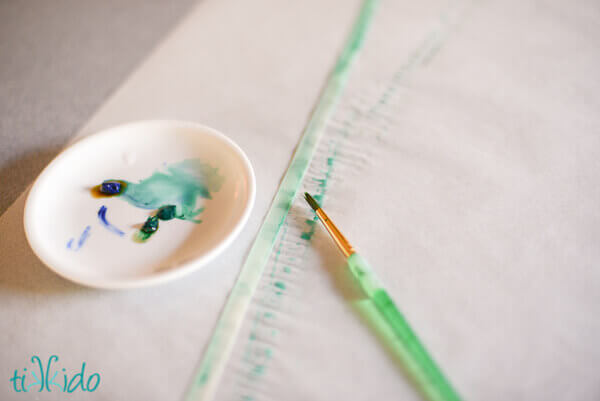 Painting white ribbon with watercolors to make beautiful, custom painted ribbon.