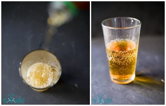 Sparkling Apple Cider in a clear glass on a black background