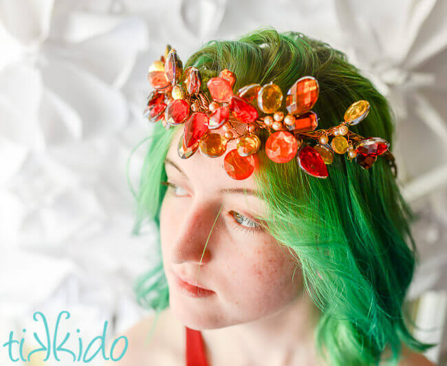 Girl with green hair wearing a crown made with rhinestones in fall colors and champagne pearls.