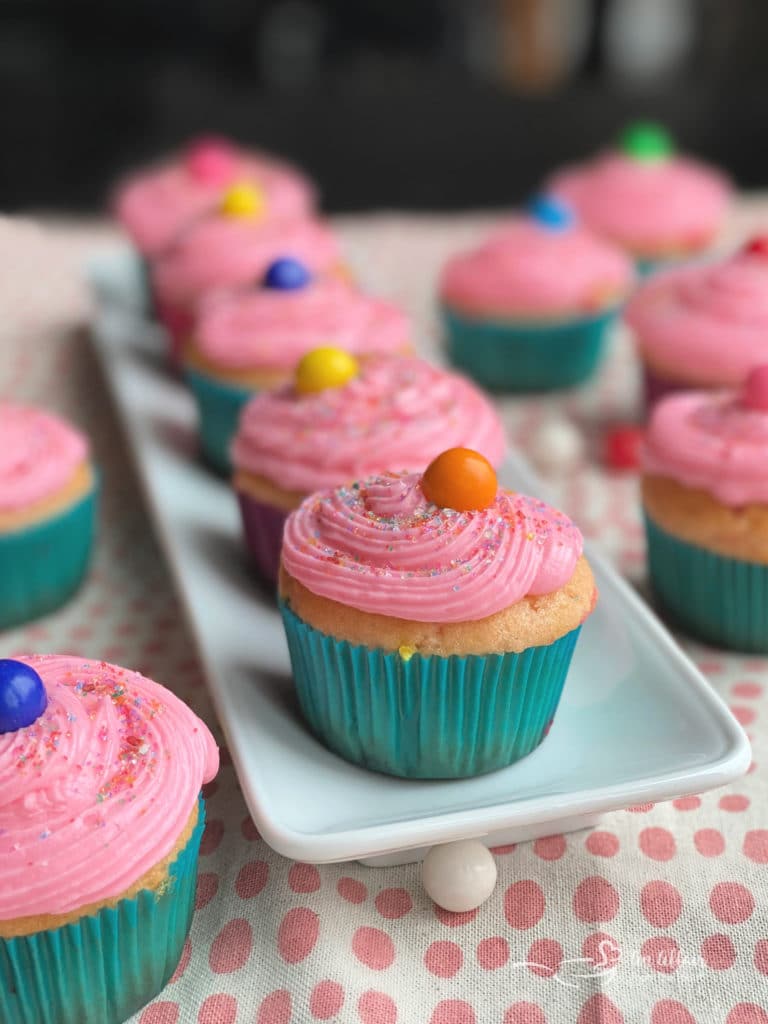 Pink Bubblegum Cupcakes with bubblegum frosting on a white tray.