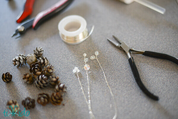 materials for a pinecone napkin ring on a grey countertop.