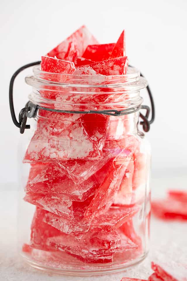 Glas jar full of cinnamon hard candy pieces.