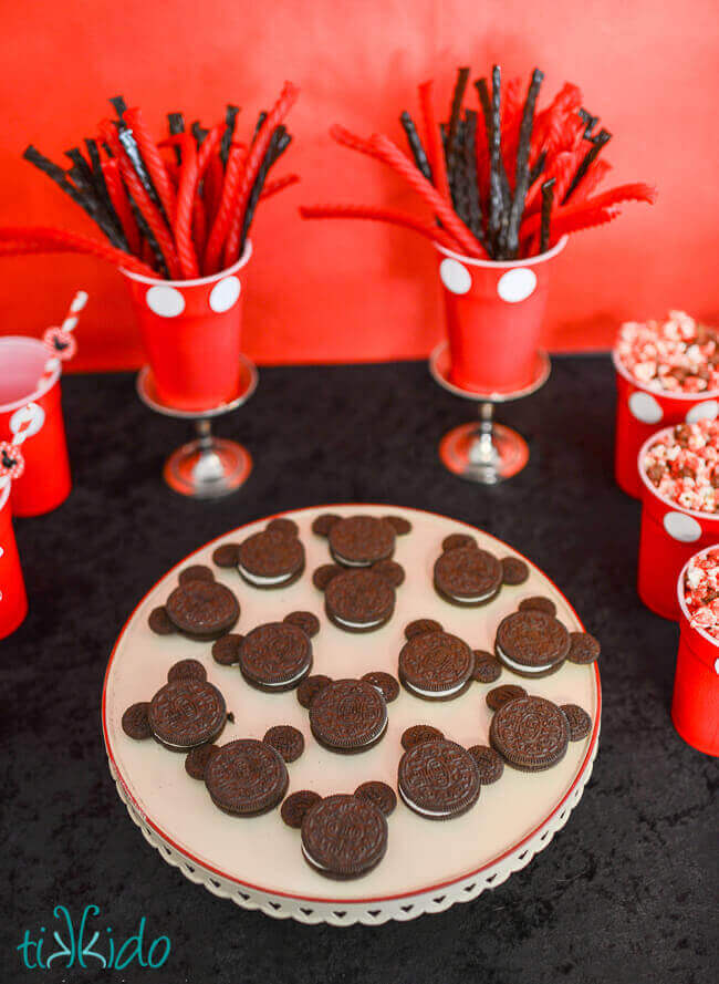 Mickey Mouse cookies made with Oreos on a cream colored cake plate.