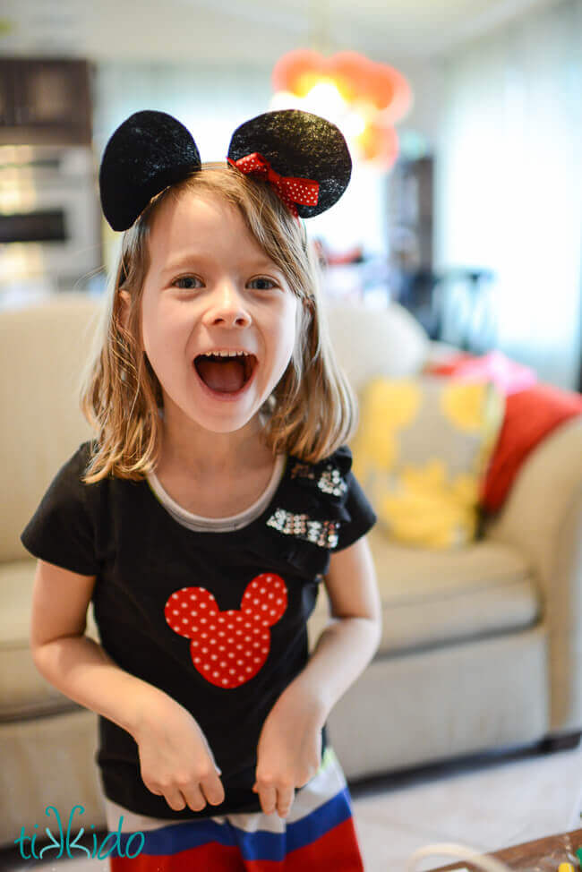 Happy little girl wearing Easy Felt Mickey Mouse Ears Headband.