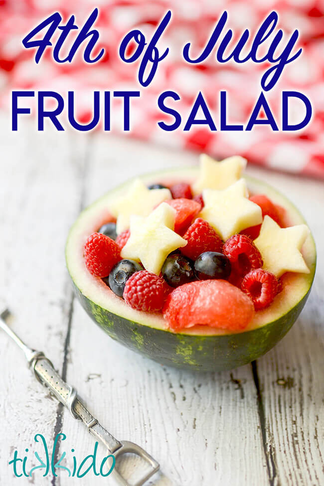 Watermelon bowl filled with red, white, and blue fruit, including apples cut into stars, to make a 4th of July fruit salad.