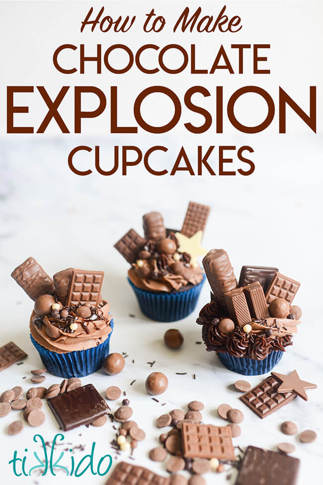 Three chocolate explosion cupcakes on a white background, with chocolates scattered around, and text overlay reading "How to Make Chocolate Explosion Cupcakes."
