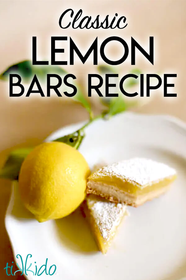 Two lemon bars on a white plate, next to a fresh, whole lemon, with text overlay reading "Classic Lemon Bars Recipe."