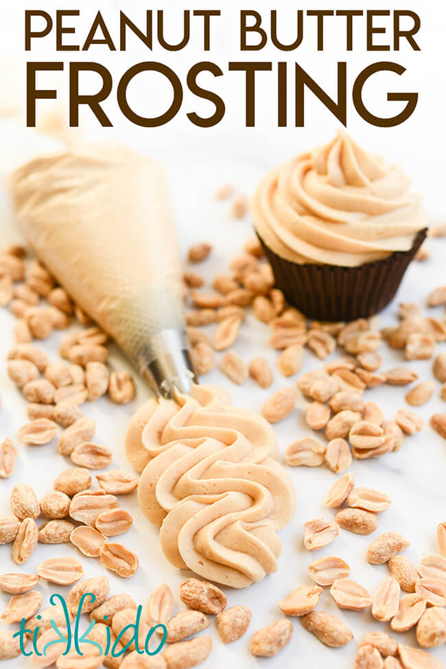 Peanut butter frosting piped on a marble surface, surrounded by peanuts and a chocolate cupcake topped with Peanut Butter Frosting.