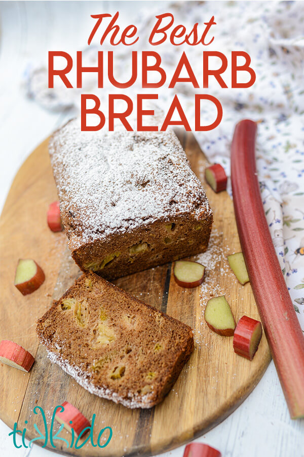 Rhubarb bread dusted with powdered sugar, sliced on a wooden cutting board, with slices and a stalk of rhubarb surrounding it.  Text overlay reads "The Best Rhubarb Bread."