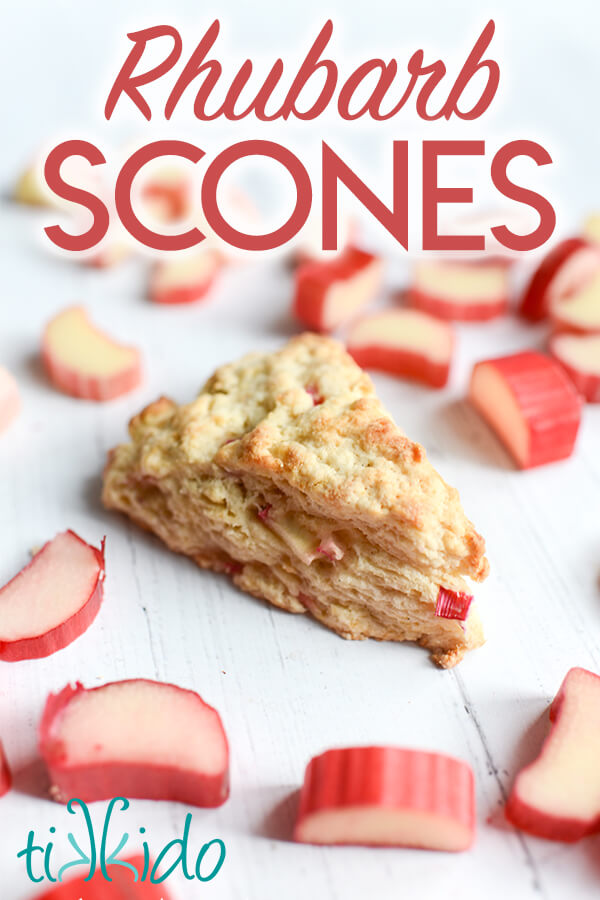 Rhubarb scone surrounded by slices of fresh rhubarb, with text overlay reading "Rhubarb Scones."