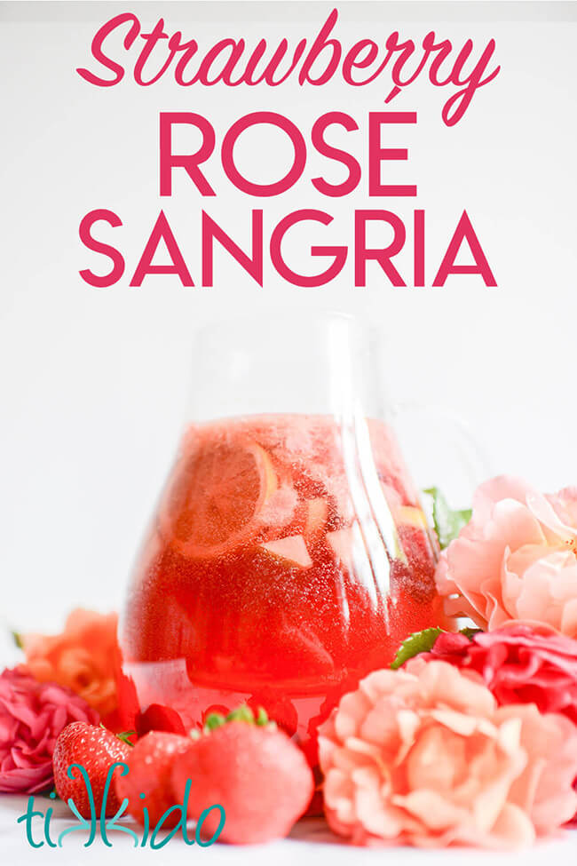 Pitcher of Rosé Sangria surrounded by strawberries and roses, with text overlay reading "Strawberry Rosé Sangria."