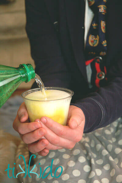 Clear liquid pouring into a clear glass and turning yellow for a Harry Potter Divinations class party trick.