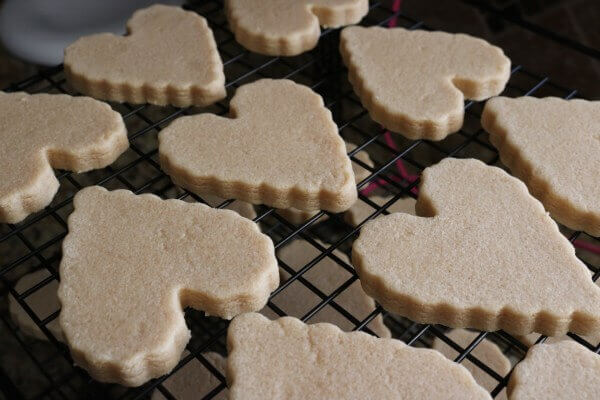 Peanut butter cut out sugar cookies cooling on a rack.
