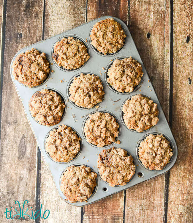 crumb topped applesauce spice muffins baked in a muffin tin.