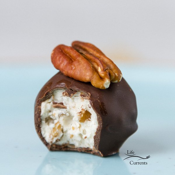 Pecan Bourbon Ball Old Fashioned Candy on a white surface.