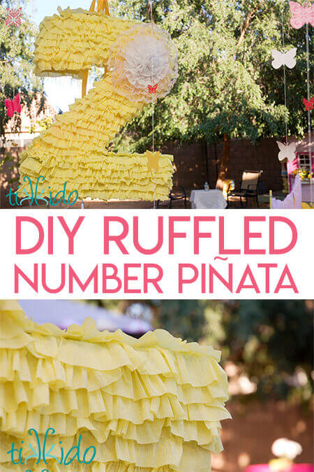 Store bought piñata shaped like a number 2 covered in light yellow ruffled crepe paper.