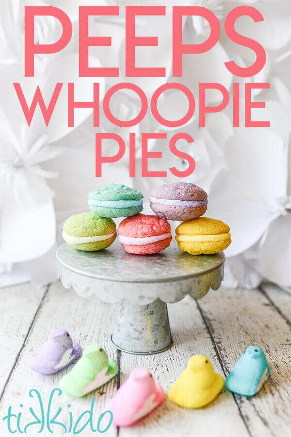 Five Peeps Whoopie pie sandwich cookies on a galvanized metal cake stand, surrounded by five Peeps candies in five different colors.