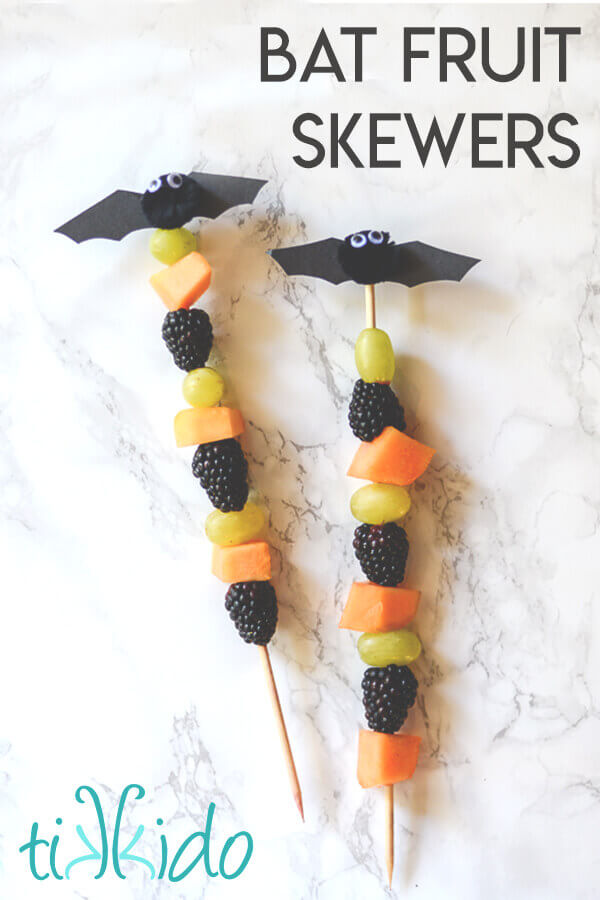 Halloween fruit skewers topped with cute little pom pom bats.
