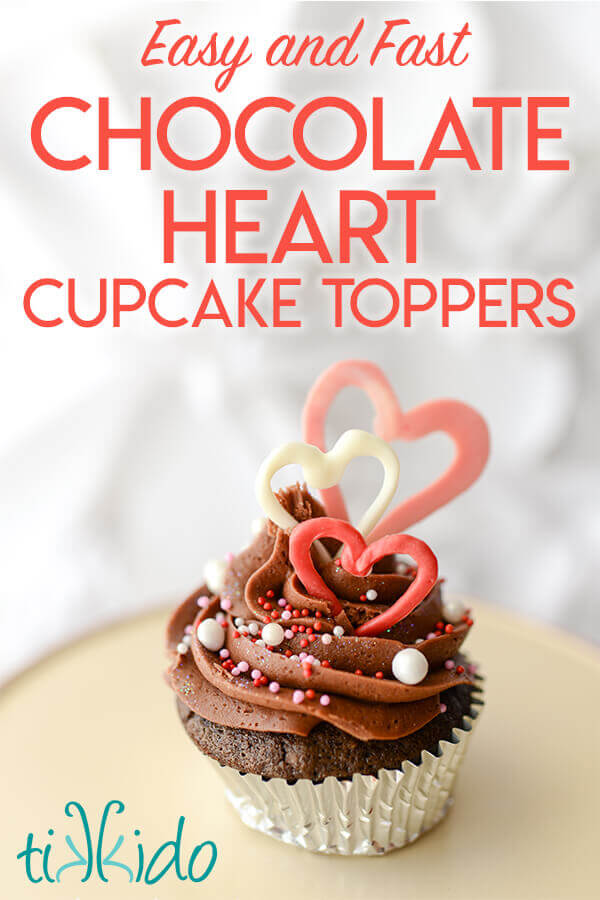 Valentine's day cupcake decorated with sprinkles and chocolate heart cupcake toppers.
