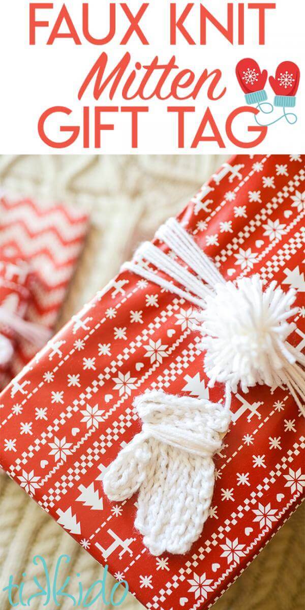 Gift tag that looks like a white knit mitten on a package wrapped with red and white nordic print wrapping paper.