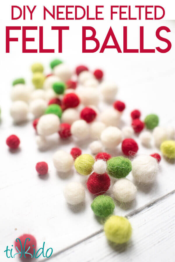 Felt balls made with needle felting on a white wooden background.