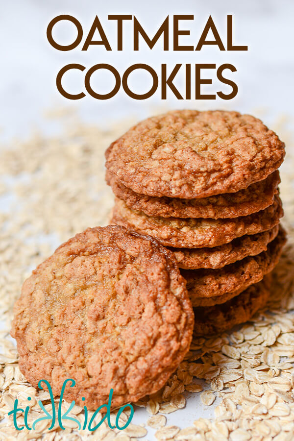 Oatmeal cookies stacked and surrounded by rolled oats.