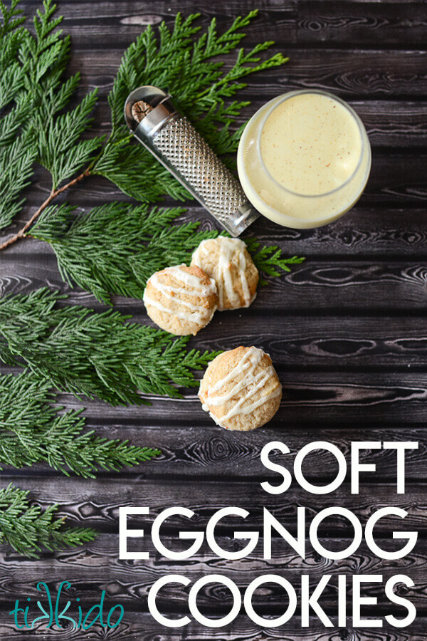 Three eggnog cookies and a glass of eggnog on a dark wooden surface, with text overlay reading "Soft Eggnog Cookies."