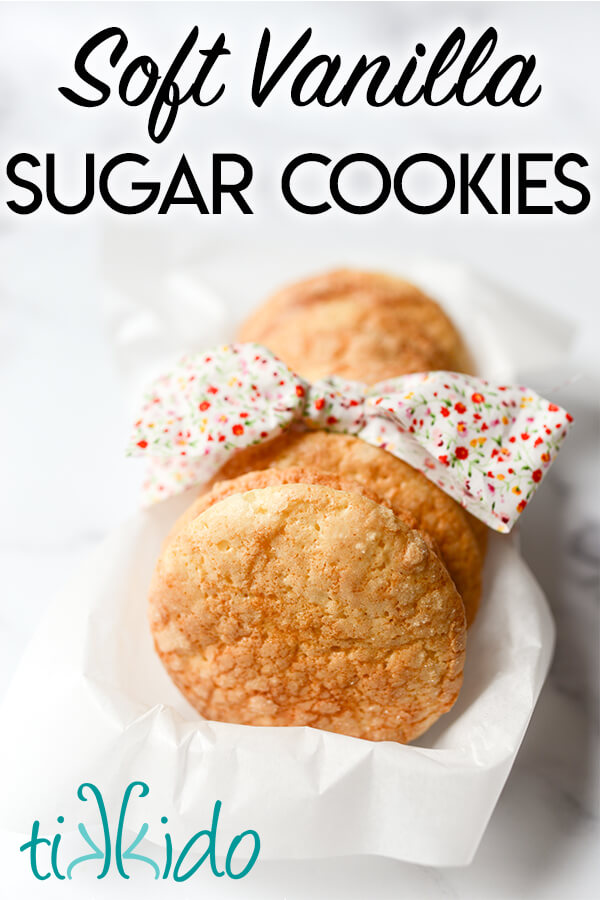 Soft Sugar Cookies in a parchment lined container, tied with a floral print ribbon.