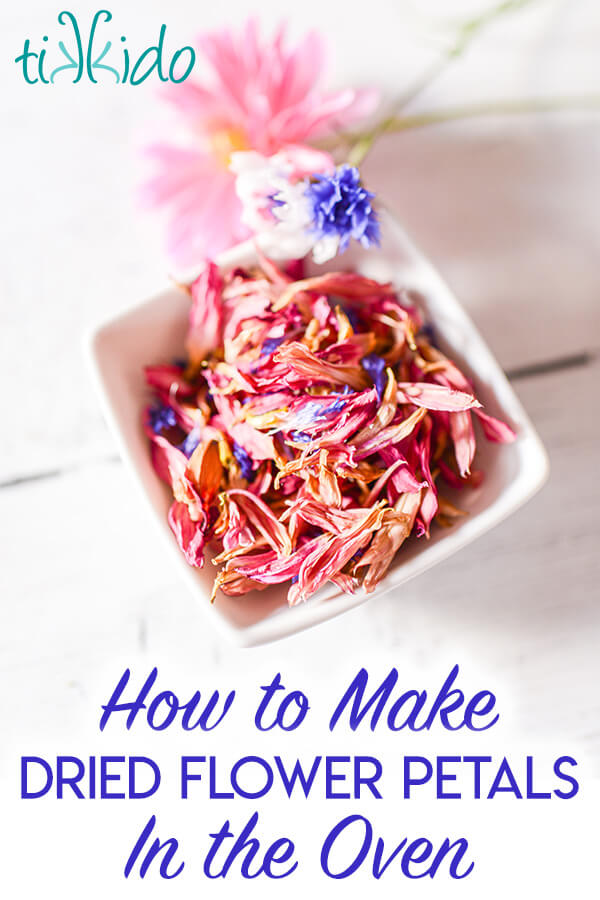 Square white bowl filled with dried pink and blue edible flower petals, with text overlay reading "How to Make Dried Flower Petals in the Oven."