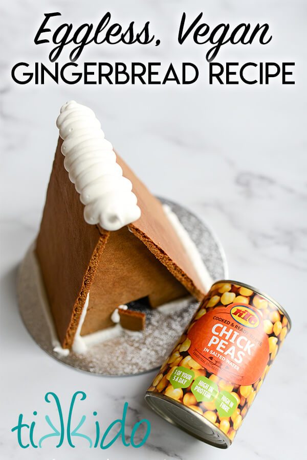 Vegan gingerbread house next to a can of chickpeas, with text overlay reading "Eggless, vegan gingerbread recipe."