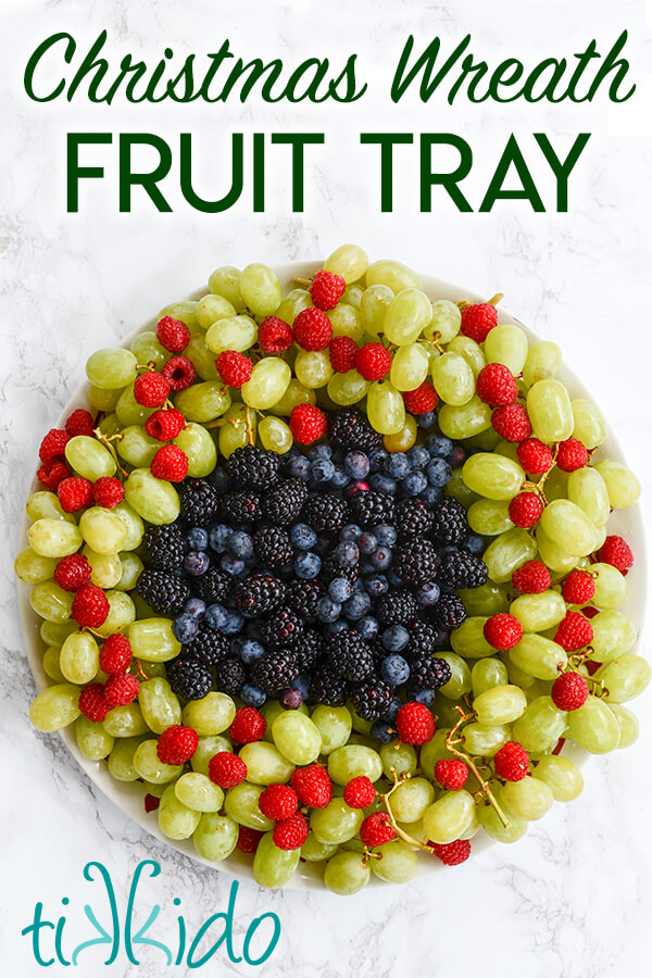 Christmas fruit tray that looks like a Christmas wreath, with text overlay reading "Christmas Wreath Fruit Tray."