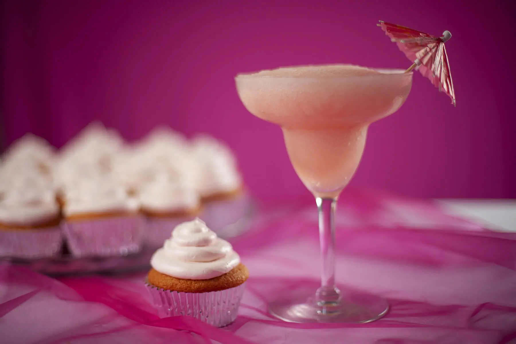 Pink Grapefruit Daiquiri Cupcakes next to a Pink Grapefruit Daiquiri.