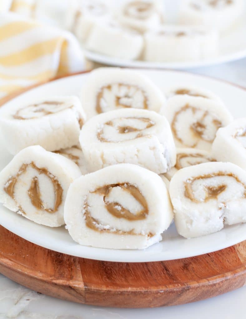 Old Fashioned Potato Candy on a white plate on a wooden cutting board.