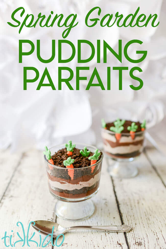 Two miniature trifle dishes filled with layers of chocolate pudding, chocolate whipped cream, and crushed oreo dirt, with white chocolate carrots planted in the top layer.