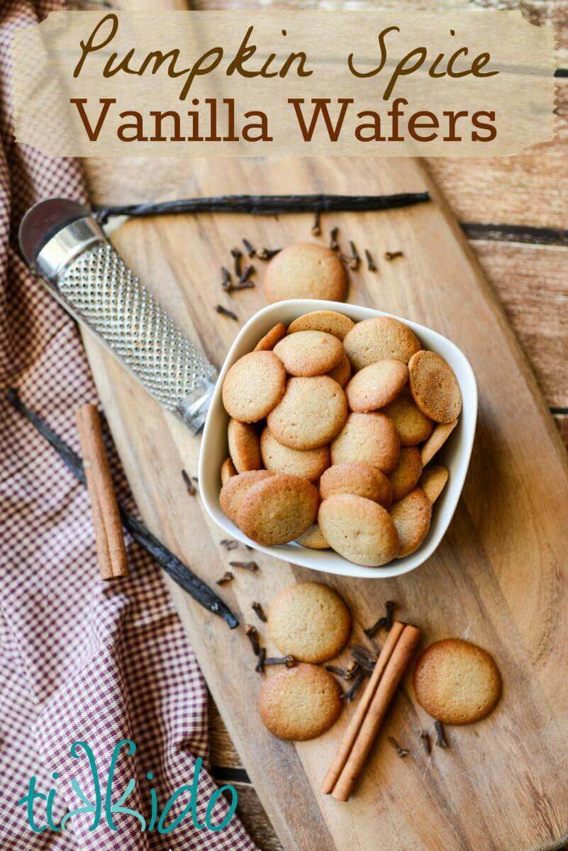 Pumpkin Spice Vanilla Wafer Cookies on a wooden cutting board surrounded by whole spices.