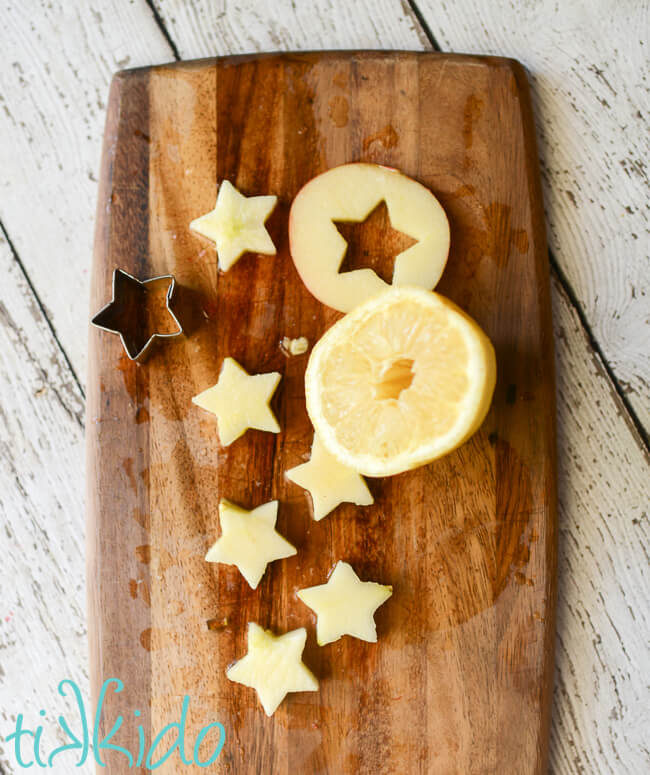 Apple slices being cut into star shapes for 4th of July Fruit Salad.