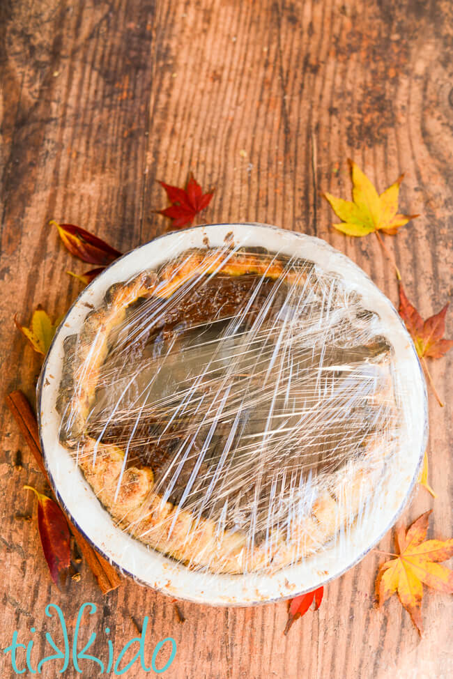 Apple butter pie baked, cooled, and wrapped in cling film to be frozen.