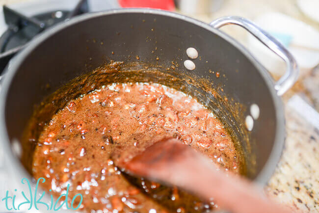 Sauce pan on stove filled with bubbling, melted ingredients for Praline Ice Cream Topping