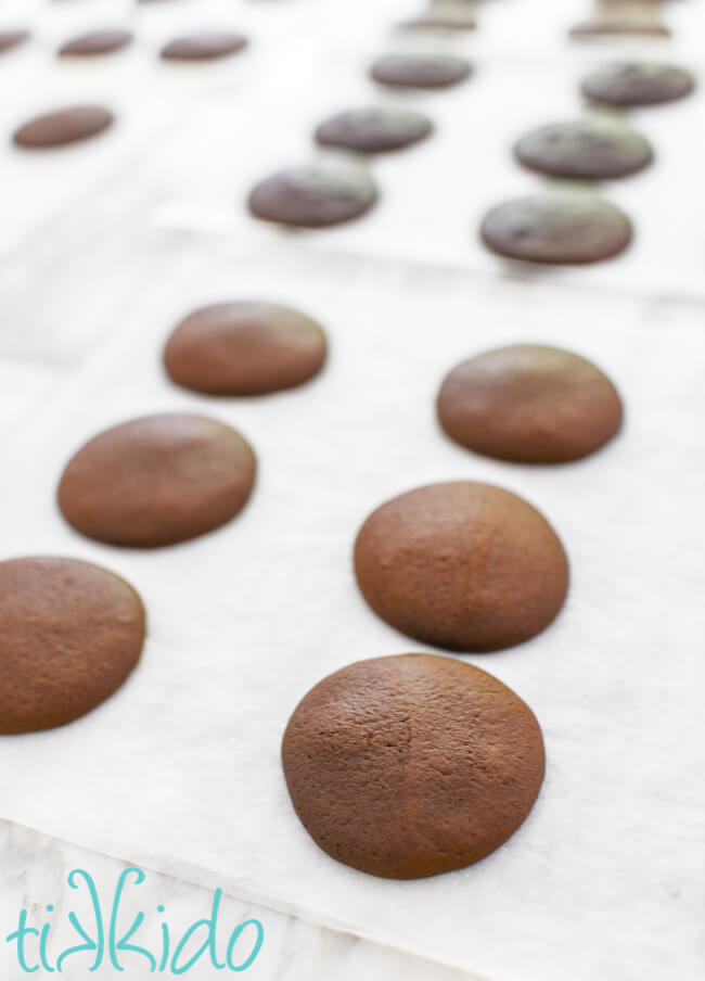 Cookie portion of Whoopie Pies cooling on a marble table.