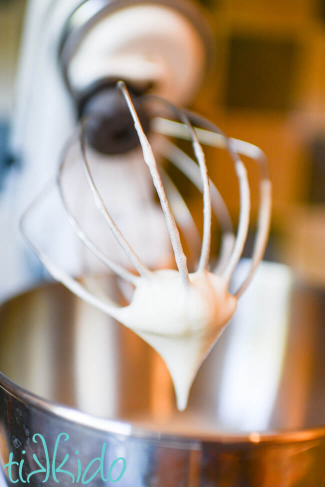 Egg whites being whipped with a whisk attachment of a kitchenaid mixer to make whoopie pie filling.