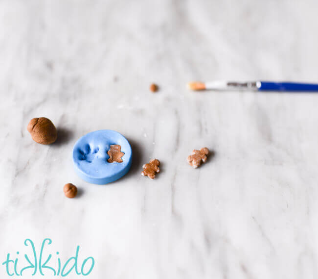 Tiny silicone mold being used to make dollhouse sized gingerbread cookies.